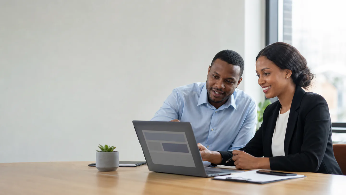 Business owner and web designer reviewing a website